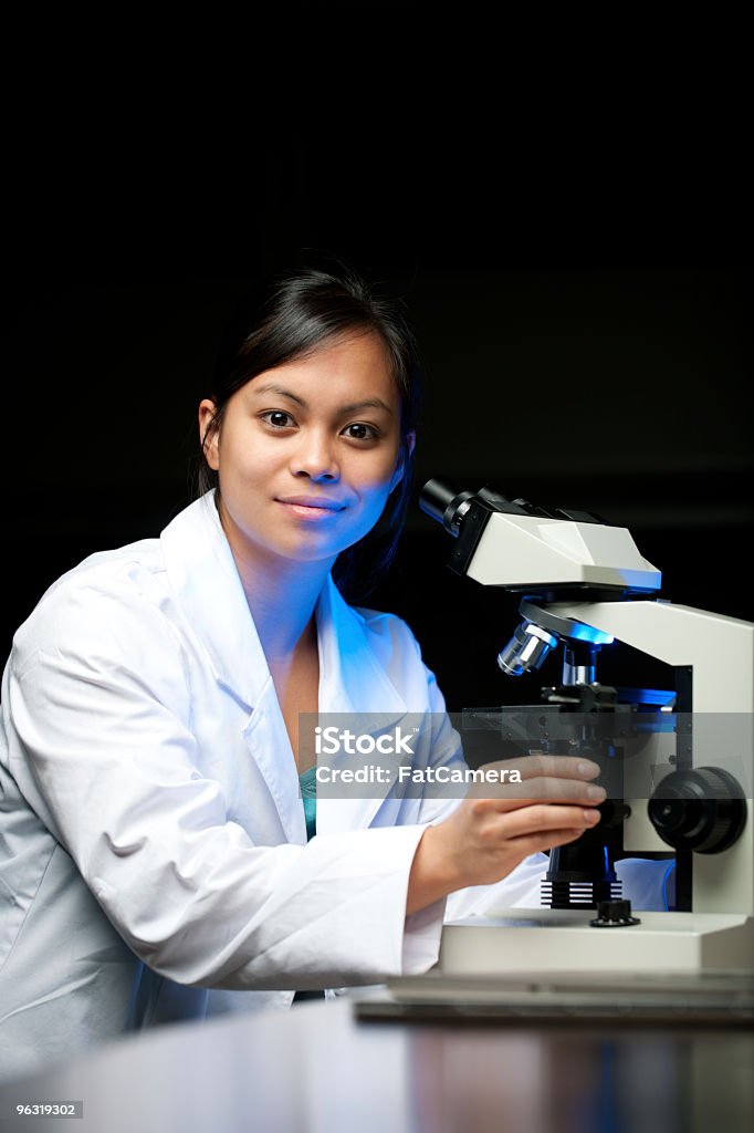 Scientific Research A college student/young scientist using a microscope 20-29 Years Stock Photo