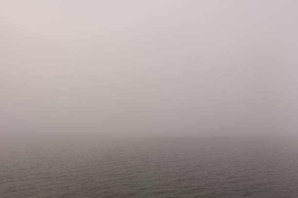 istock Heavy fog over morning calm water surface. 963195218