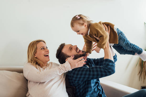 istock Father holding a child and mother looking gently 963195766