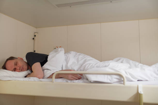 istock Man sleeping in a cabin of cruise ship 963198104