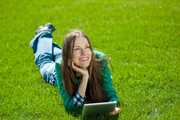 istock Young woman using tablet outdoor 963216356