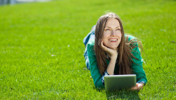 istock Young woman using tablet outdoor 963216382