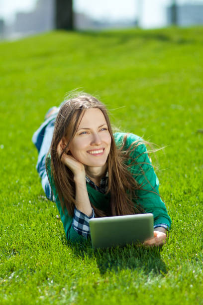 istock Young woman using tablet outdoor 963216388