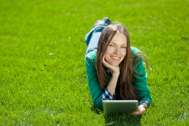 istock Young woman using tablet outdoor 963216754