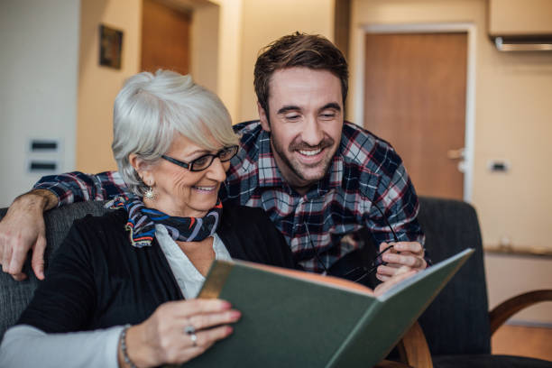 istock Mother and son reading together at home 963225524