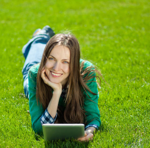 istock Young woman using tablet outdoor 963226898