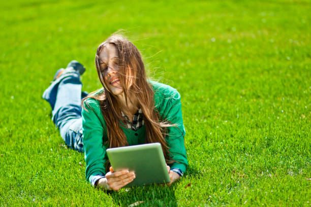 istock Young woman using tablet outdoor 963226922