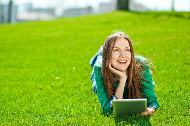 istock Young woman using tablet outdoor 963226934