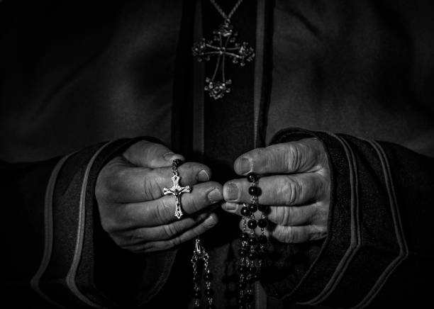 Young man with hands on his chest receives individual prayer during religious service.