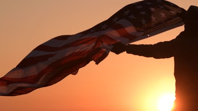 American Patriot with USA Flag During Scenic Sunset