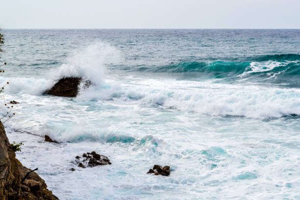 istock Big waves breaking on the shore with sea foam 963239068