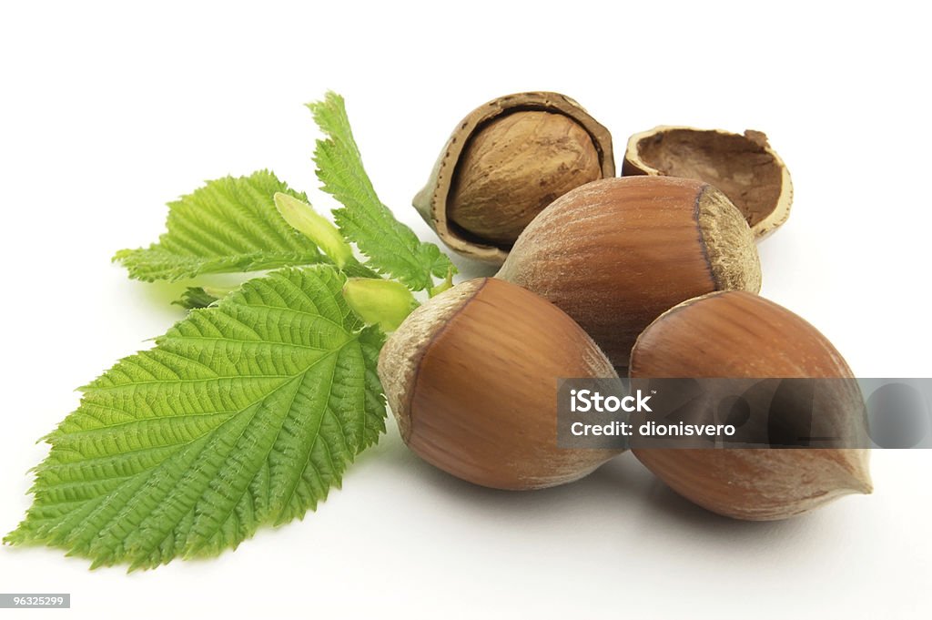 A few hazelnuts together on a white background Hazelnuts with leaves Brown Stock Photo