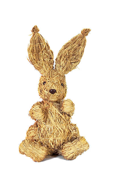 Decorative straw bunny features large ears and a cheerful face, perfect for festive occasions and seasonal decor.