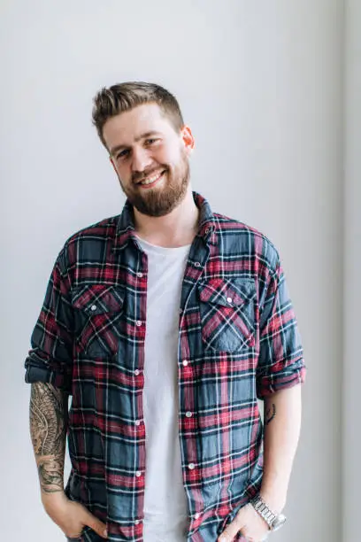 Portrait of a young modern teacher. Male with casual clothes and tattoo