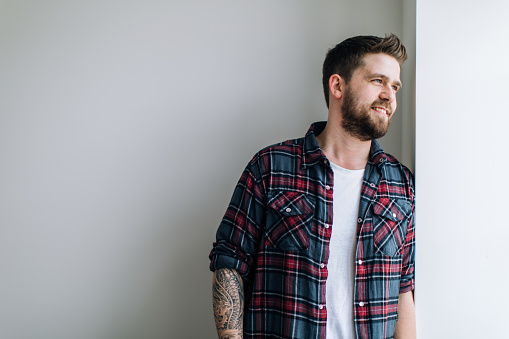 Portrait of a young modern teacher. Male with casual clothes and tattoo