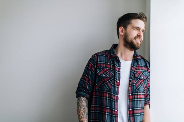 Portrait of a young modern teacher. Male with casual clothes and tattoo Portrait of a young modern teacher. Male with casual clothes and tattoo dream believe tattoo stock pictures, royalty-free photos & images
