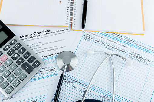 Stethoscope and calculator for health medical insurance