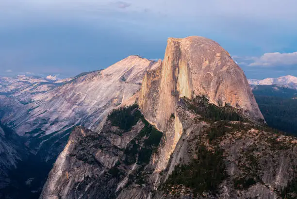 The view of Half Dome peak at dusk in Yosemite National Park.