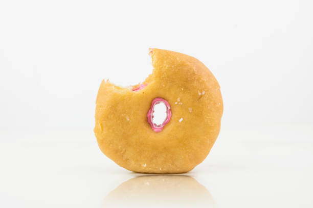 istock Bitten Delicious Pink Colored Donut On White Background With White Chocolate On It.Isolated 963287652