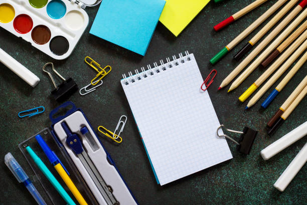 istock Back to school concept. School supplies on blackboard dark background. Top view flat lay background, copy space. 963291454