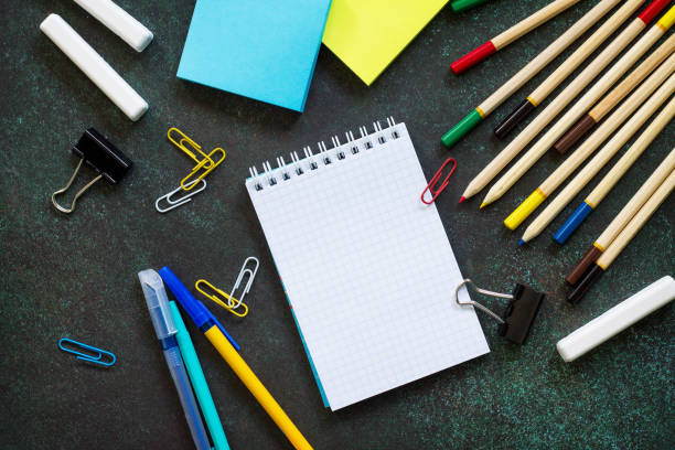 istock Back to school concept. School supplies on blackboard dark background. Top view flat lay background, copy space. 963291640