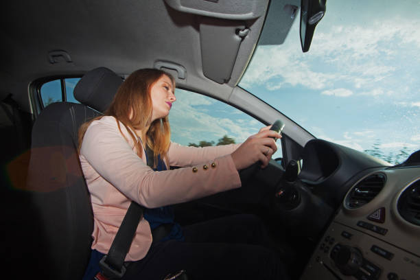 istock Young woman driving a car 963300358