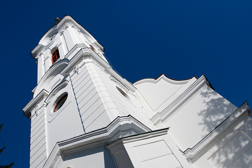 Schaan, Liechtenstein, February 13, 2022 Sun rays behind the holy Saint Peter chapel in the morning time