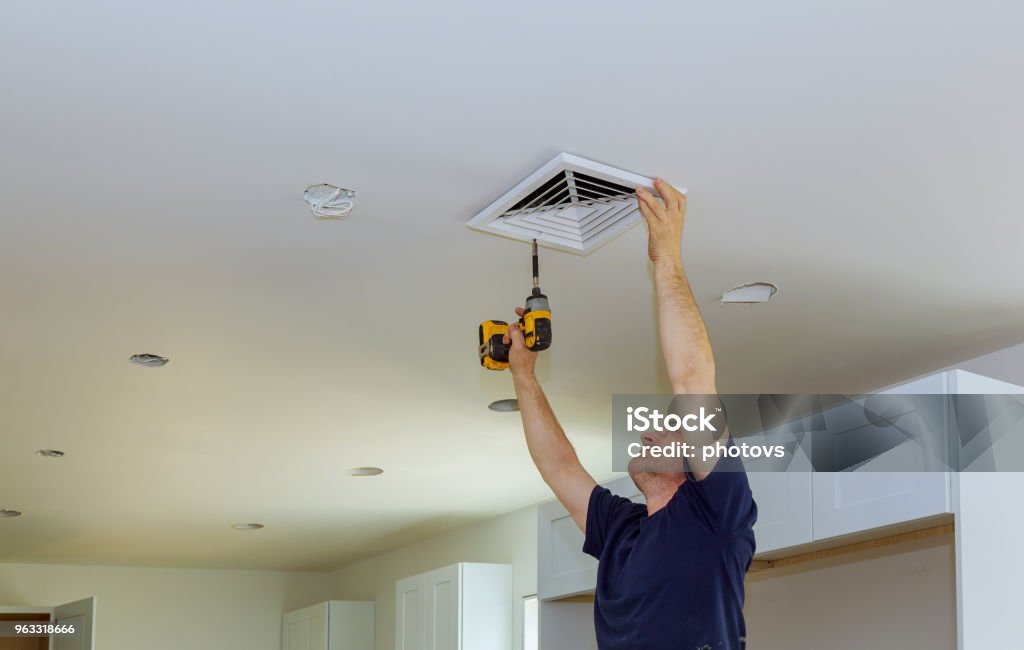 Indoor installing central air conditioning vents on the wall Indoor installing central air conditioning, vents on the wall Air Duct Stock Photo