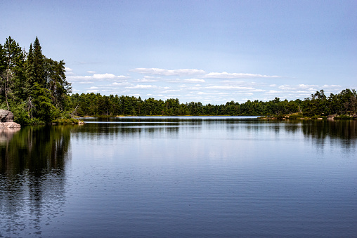 A tranquil scenic image of the French River, a heritage river with historical significance in central Ontario, Canada. Photo taken in one of the remote back country campsites of the French River Provincial Park.