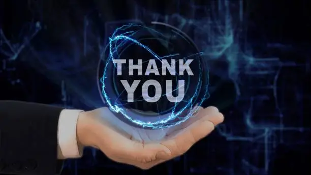 Photo of Painted hand shows concept hologram Thank you on his hand