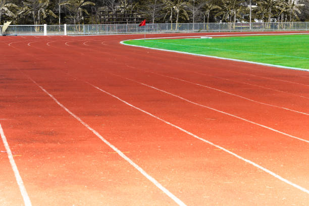 istock Red running track, white line in the stadium 963333302