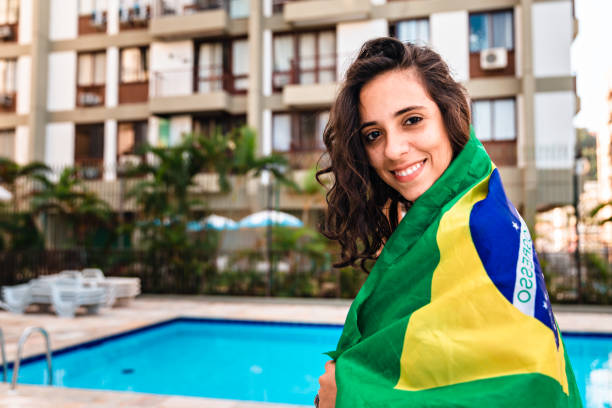 Young woman embracing Brazilian flag