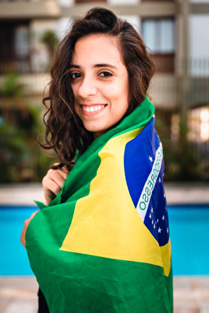 istock Young woman embracing Brazilian flag 963336634