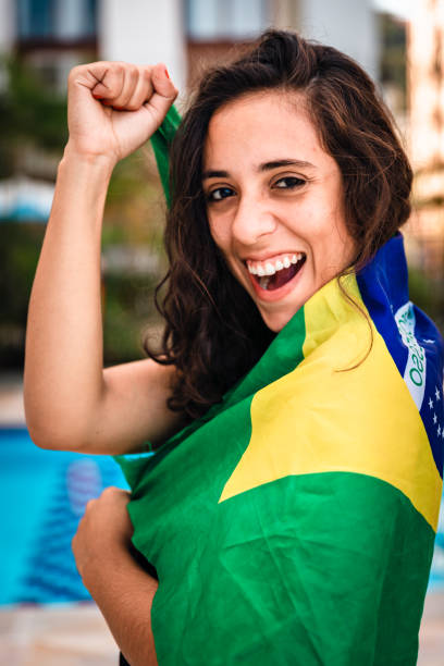 istock Young woman embracing Brazilian flag 963336748