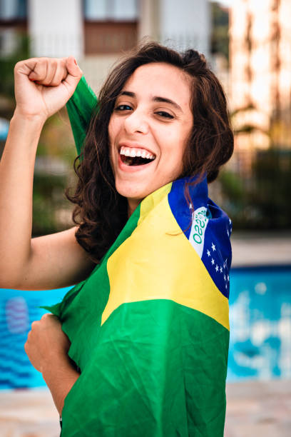 istock Young woman embracing Brazilian flag 963336752