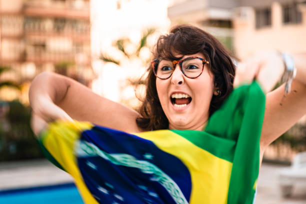 istock Cheerful young woman with Brazilian flag 963337406