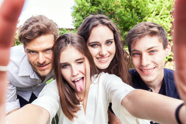 istock group of young people take a selfie hugged together 963337940