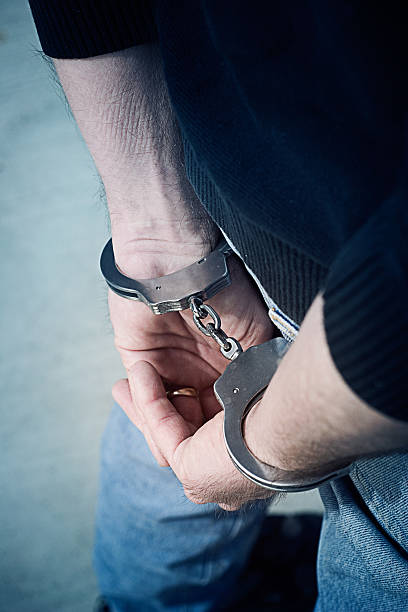 istock Close up of a mans handcuffed hands with his wedding band 96333894