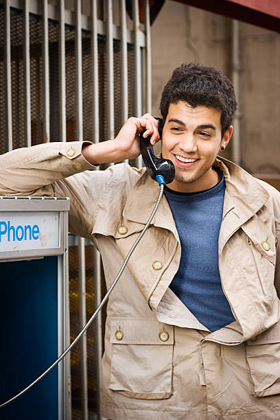 Happy Conversation  pay phone on the phone latin american and hispanic ethnicity talking stock pictures, royalty-free photos & images