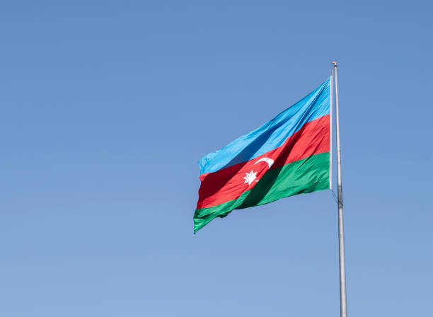The national flag of Azerbaijan on the background of blue sky The national flag of Azerbaijan on the background of blue sky baku photos stock pictures, royalty-free photos & images