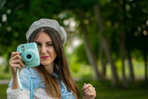 istock Girl having fun with instant camera 963346144