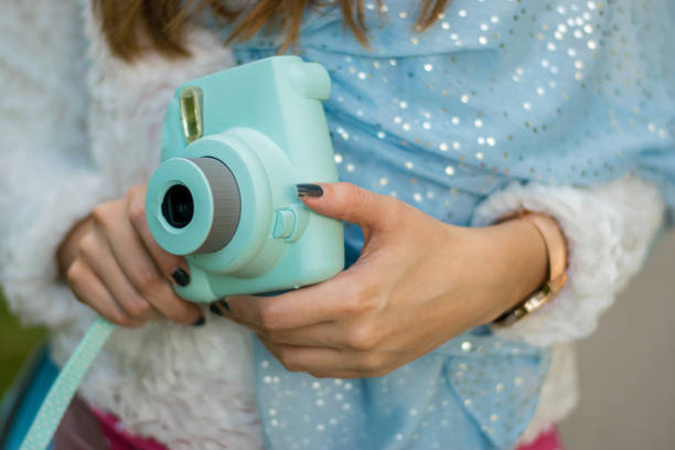 istock Girl having fun with instant camera 963346188