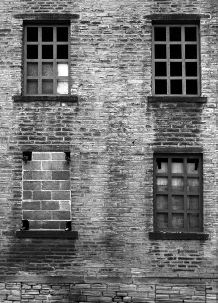 istock four broken and bricked up windows in a derelict abandoned old house 963351884