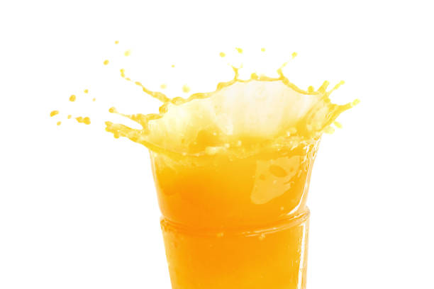 istock Orange juice splashing isolated on a white background 963362766