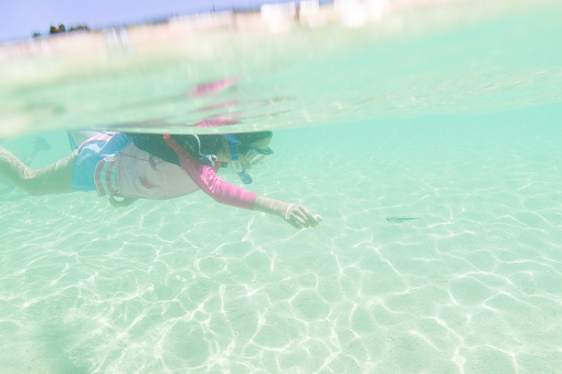 Japanese girl enjoys snorkeling in Okinawa, Japan