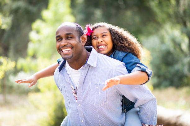 istock Playful Father and Daughter Piggyback Ride 963365956