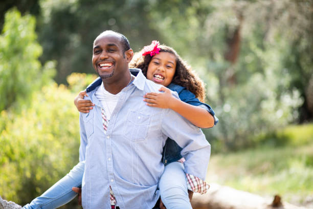 istock Playful Father and Daughter Piggyback Ride 963365970
