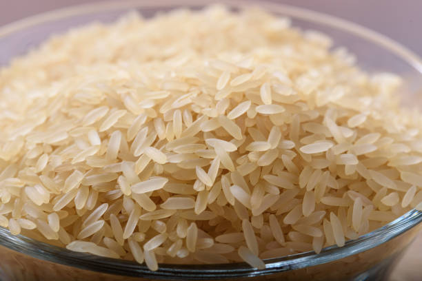 istock Bowl of uncooked parboiled rice 963379198