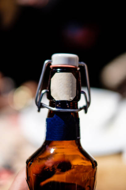 istock empty and unbranded swing top bottle of beer empty. Blurred background, blue label 963380634