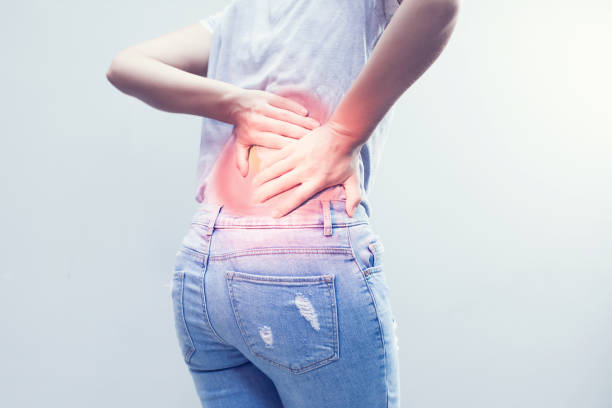 istock Portrait of young woman touching her back with pained expression, suffering from backache after long working hours, Healthy concept. 963383014